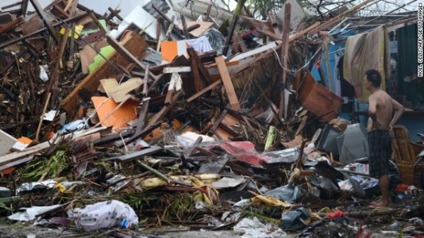 A man looks at the wreckage of destroyed houses in Tacloban on November 10, 2013.  Source: cnn.com 