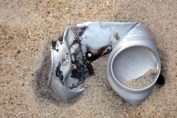 Aluminum drink can in beach sand ©iStock 