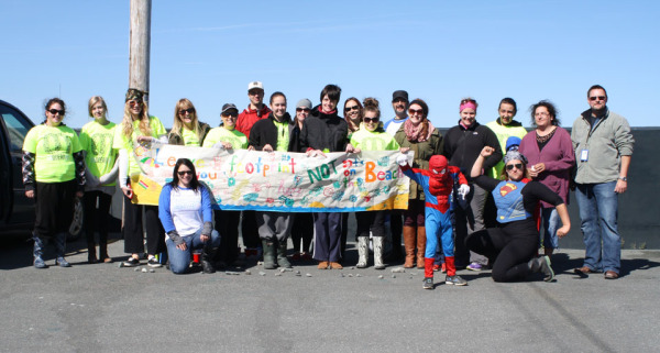 Local Spiderman joins volunteers in cleaning up St Philip’s Shoreline in St. John’s.