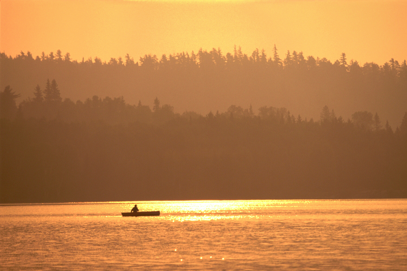 Canoeing at sunset on Willow Island Lake, Temagami area, Ontario, Canada