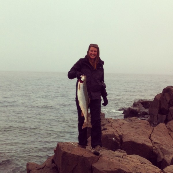 Colleen holding an Arctic char she caught with a fishing rod, in Ulukhaktok, NT. © Colleen Parker