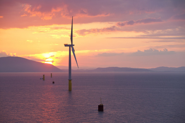 The Walney offshore windfarm from The jack up barge, Kraken, loaded with wind turbines for the Walney Offshore windfarm project, off Barrow in Furness, Cumbria, UK at sunrise. When finished it will have 102, 3.6 MW turbines, giving a total capacity of the Walney project of 367.2 MW, enough to power 320,000 homes. The rotor diameter of the turbines is 107m for Walney 1 and 120 m for Walney 2. The wind farm is owned and constructed by Dong Energy.