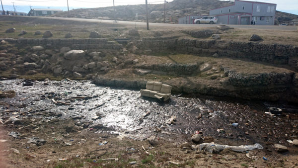 The creek by WWF’s Iqaluit office before the cleanup. © Aviaq Johnston