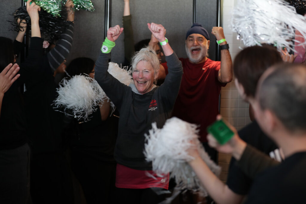 volunteers cheer for people reaching the top of the CN Tower