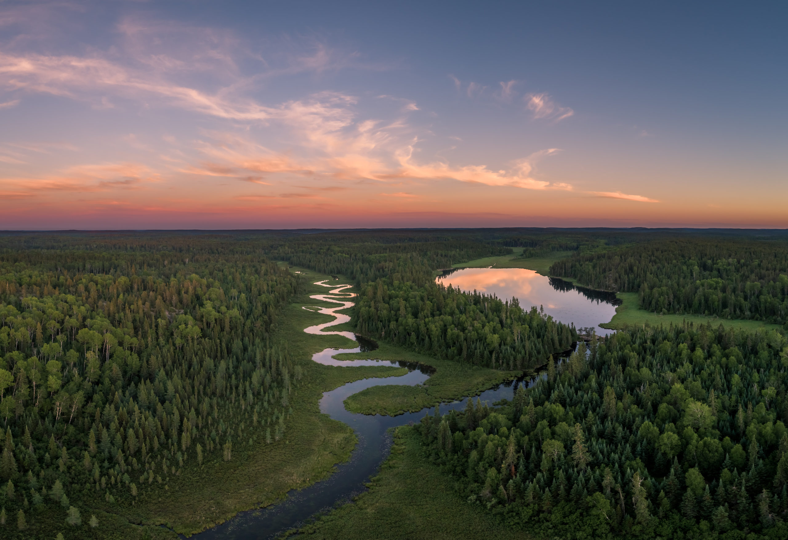 Aerial view of a winding river and trees in Northern Ontario