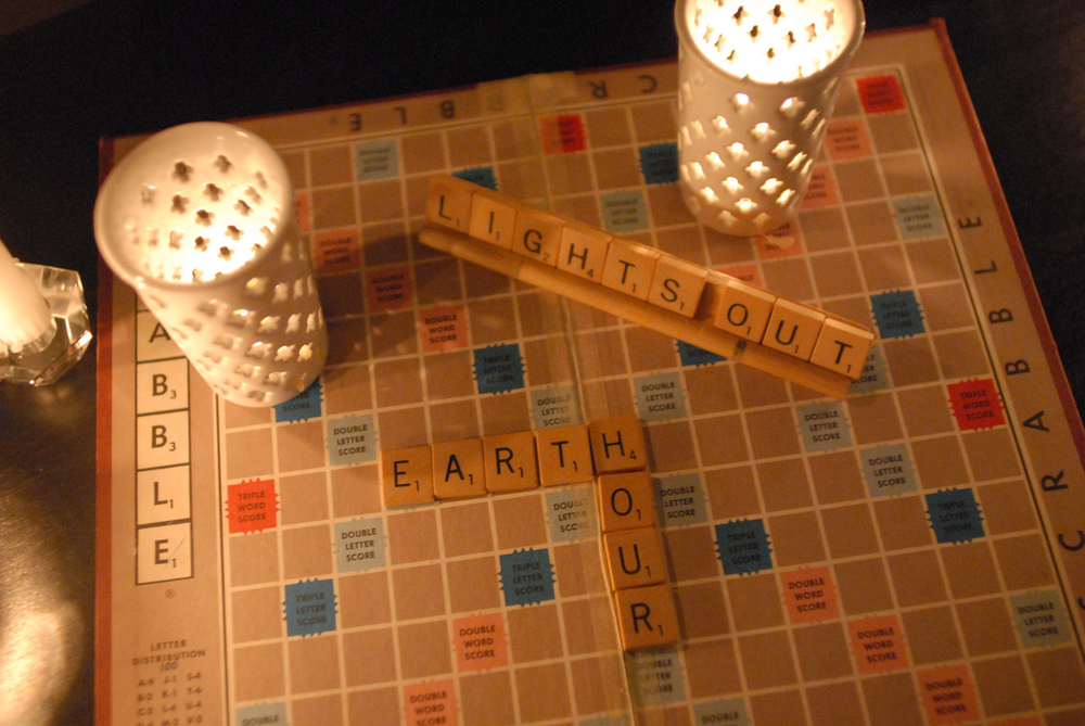 Earth Hour 2009. A candle-lit Scrabble board spelling "lights out" and "Earth Hour."