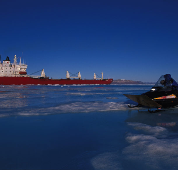 An Inuk man watches an icebreaker, Nunavut, Canada