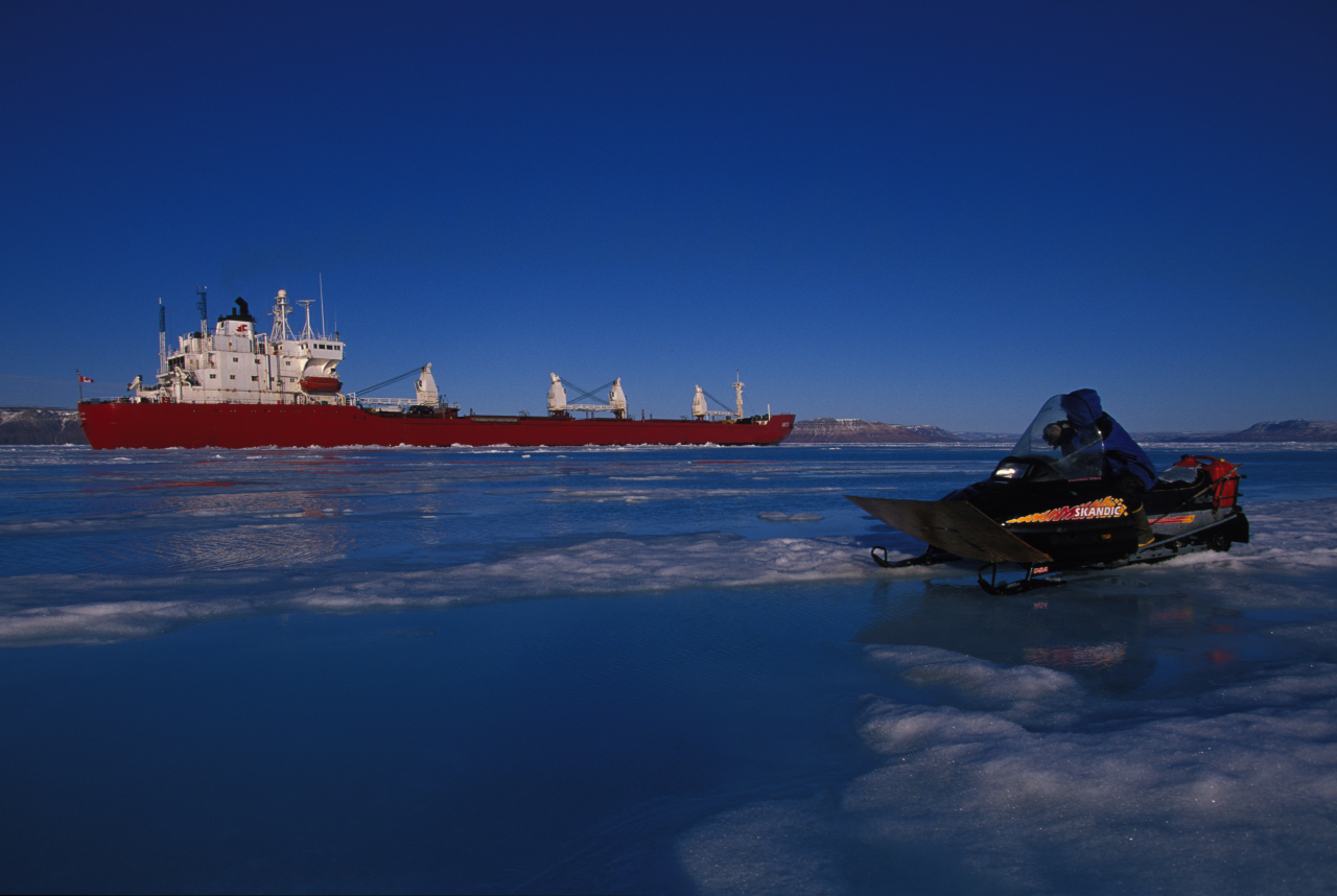 An Inuk man watches an icebreaker, Nunavut, Canada