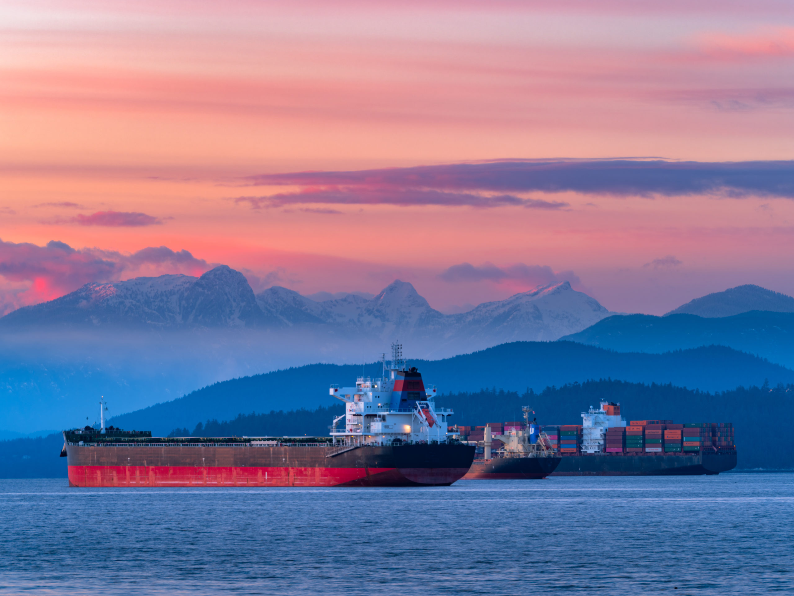 Freighters stop at the bay of Vancouver at sunset.