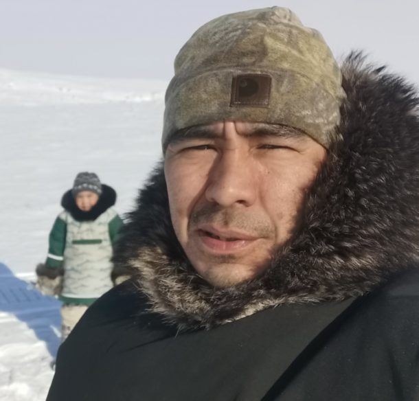 Inuit man and son out on the land in winter