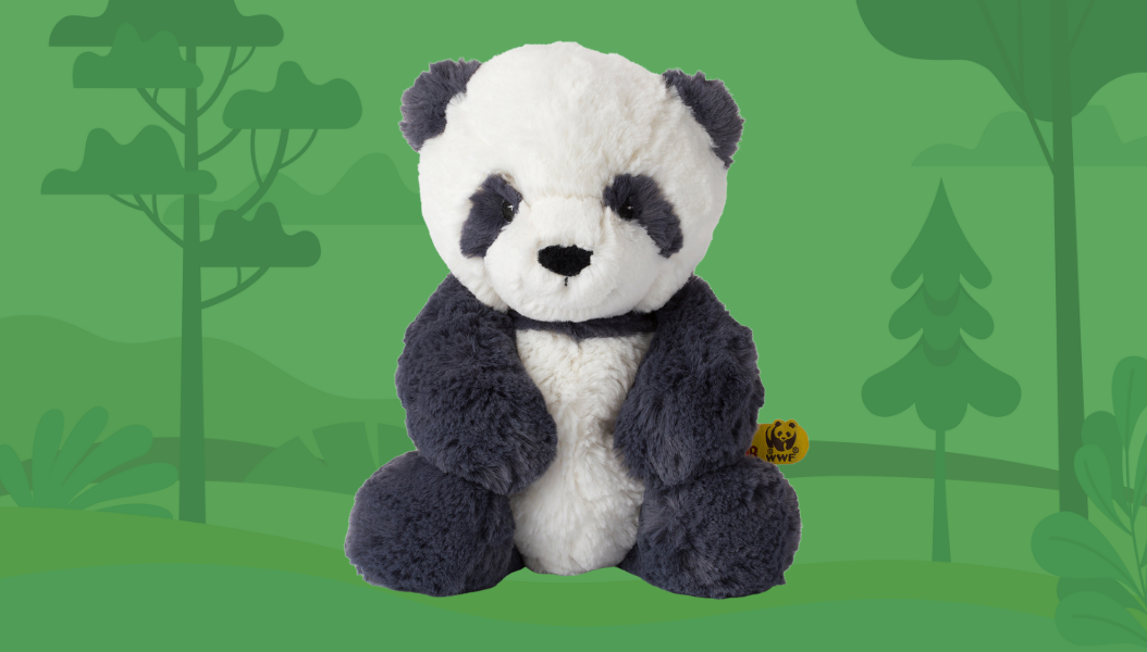 Panu Panda infant stuffie on a green forest background