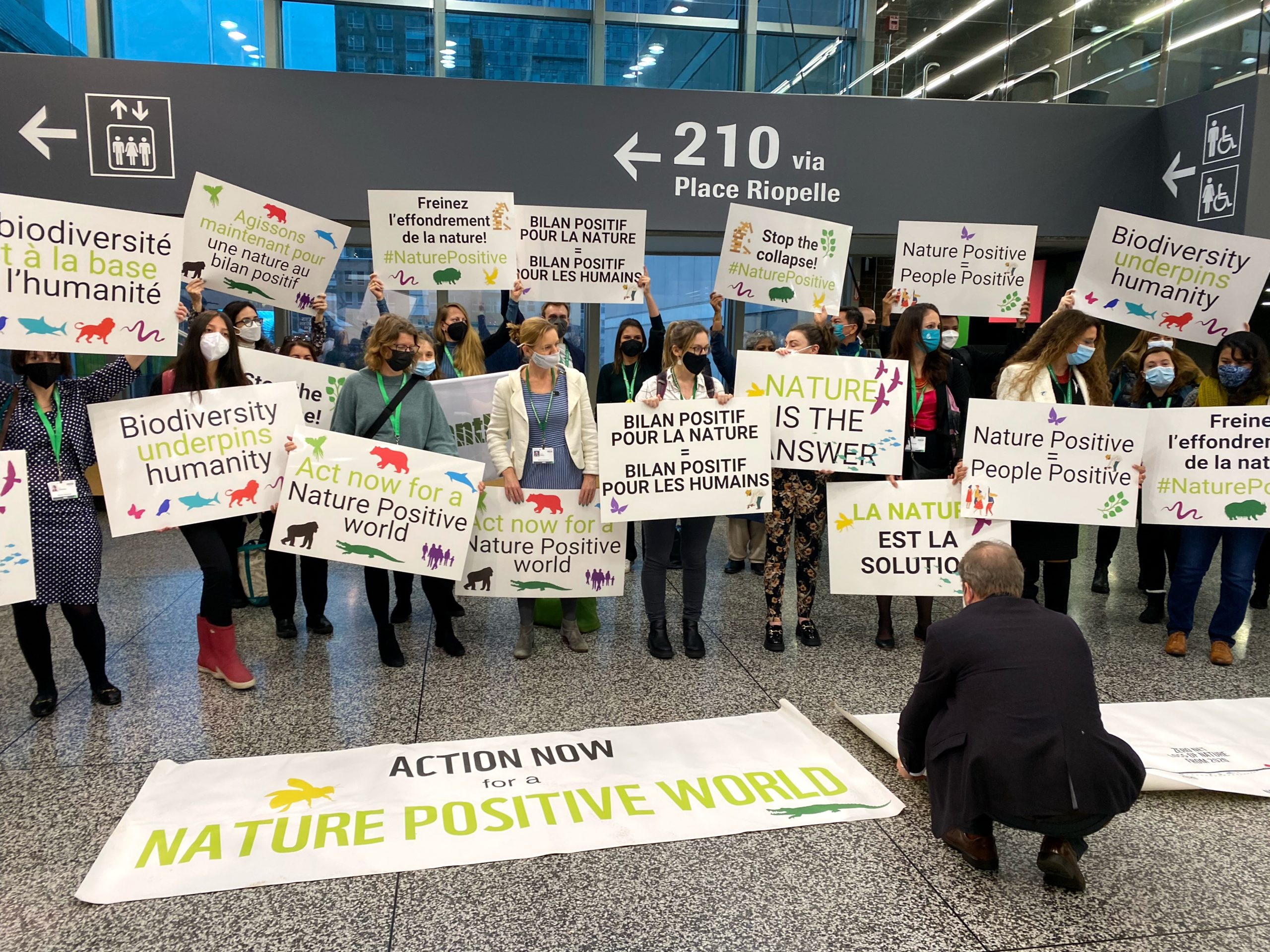 Demonstrators with pro-biodiversity signs