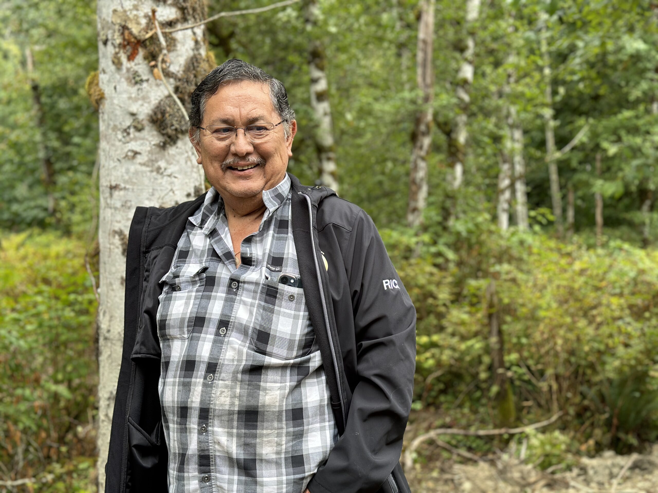 Katzie First Nation man standing in a green forest