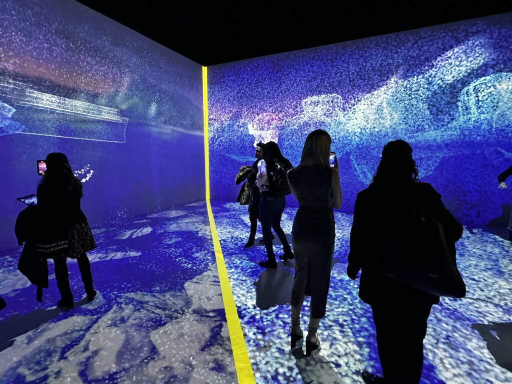 A group of people explore WWF's new Regenerate Canada projection mapping room.