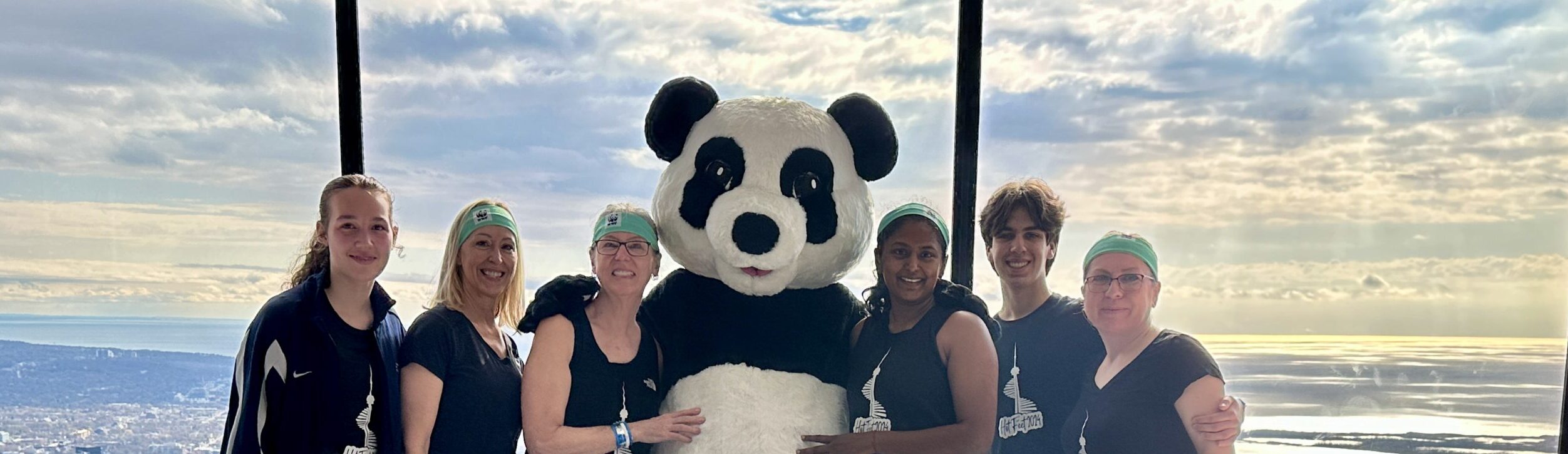 Female climbers with Panda at the observation decks o the CN Tower