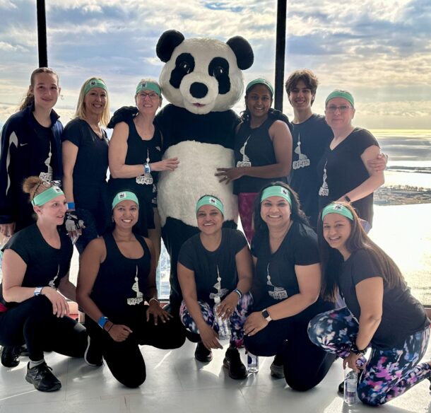 Female climbers with Panda at the observation decks o the CN Tower