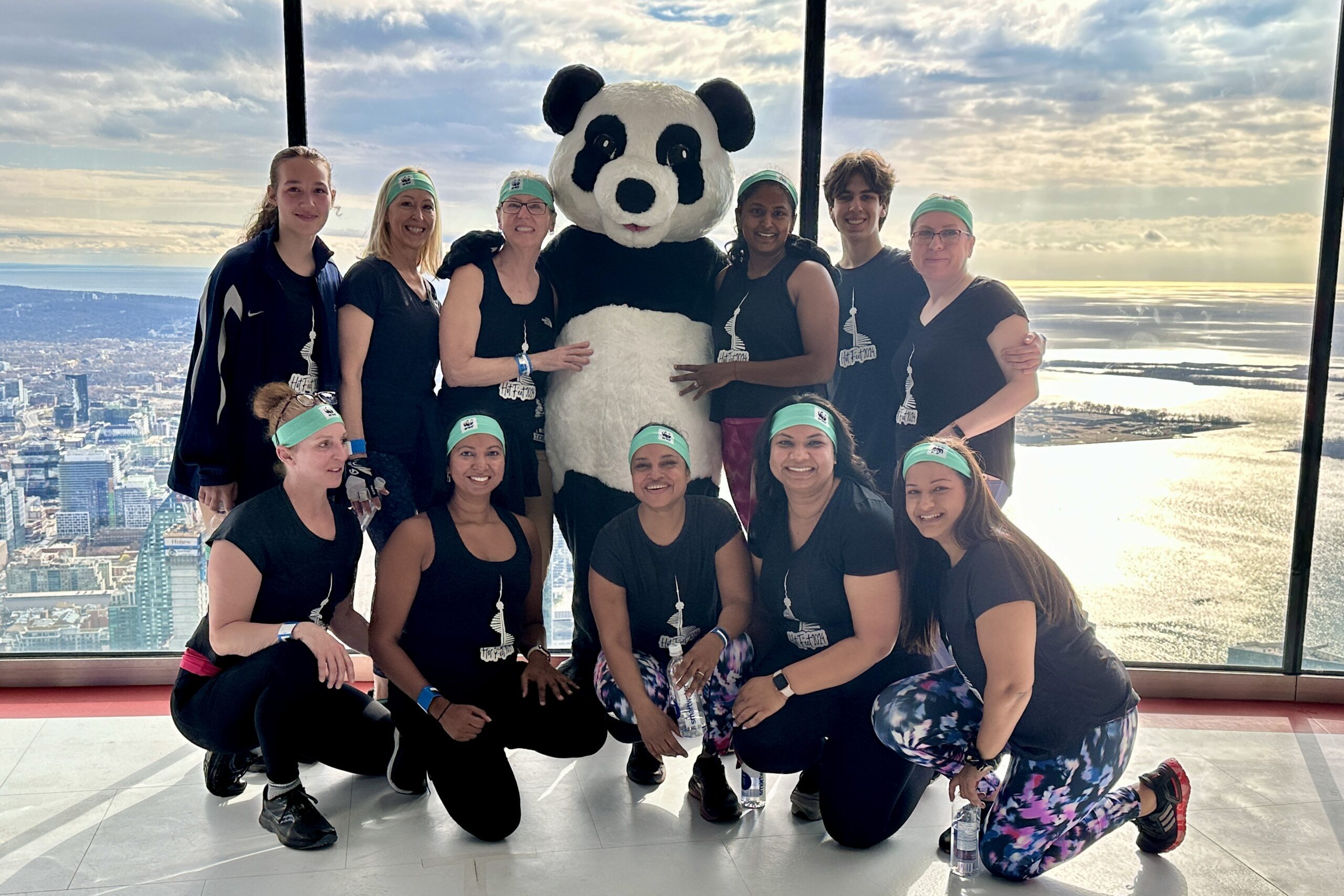 Female climbers with Panda at the observation decks o the CN Tower