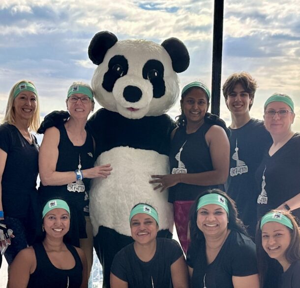 Female climbers with Panda at the observation decks o the CN Tower