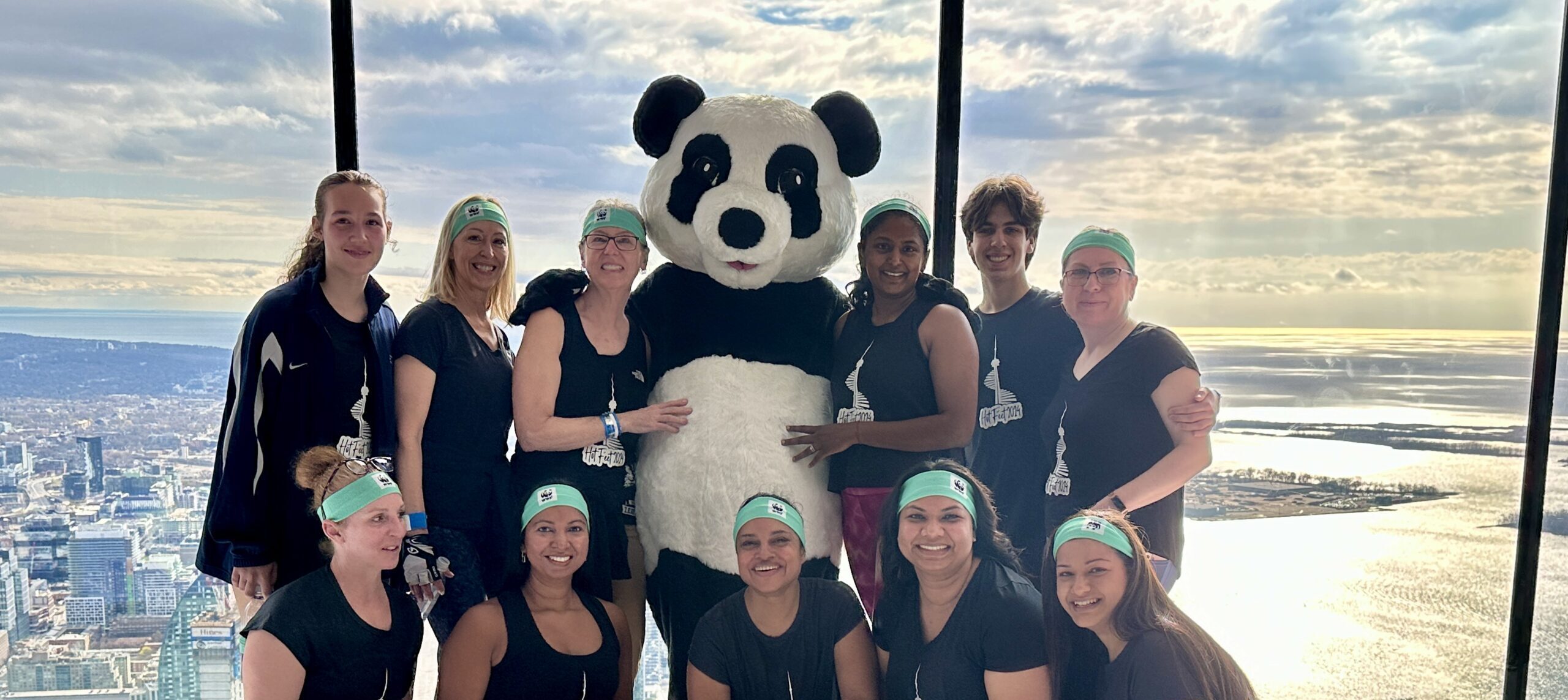 Female climbers with Panda at the observation decks o the CN Tower