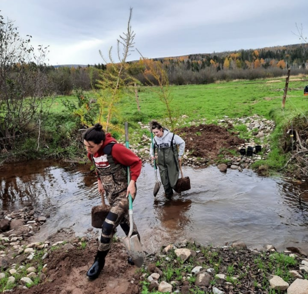 Staff members, Ashton Howe and Brooklynne King shuttle trees to a planting site along Passekeag Creek at the Gaunce farm