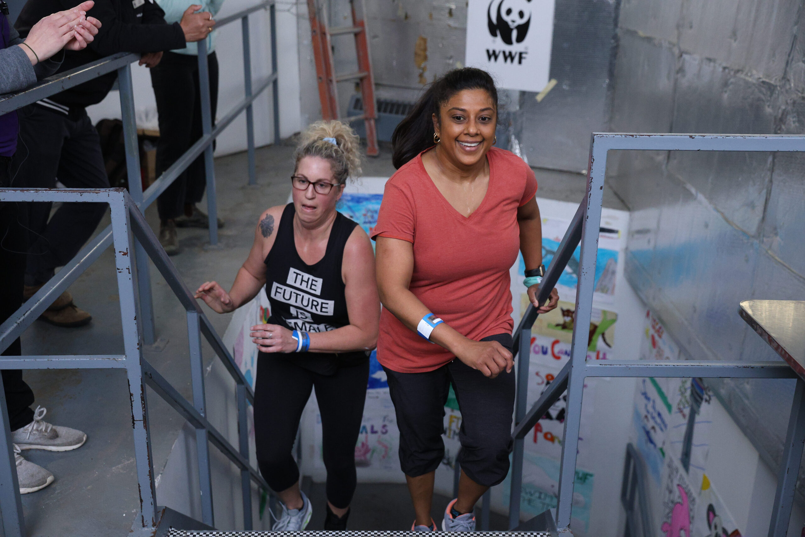 Two women approaching the finish line of the CN Tower Climb for Nature