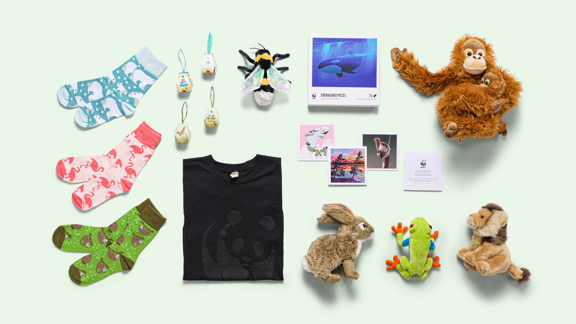 Mosaic of WWF gifts including an orangutan, bee, and red-eyes tree frog plush, three pairs of wildlife socks, a black T-shirt with the WWF logo and a puzzle.