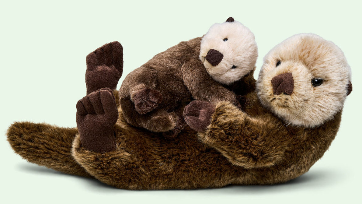 Sea otter family adoption kit, includes a mom laying on her back cuddling a pup, as if they are floating on the ocean