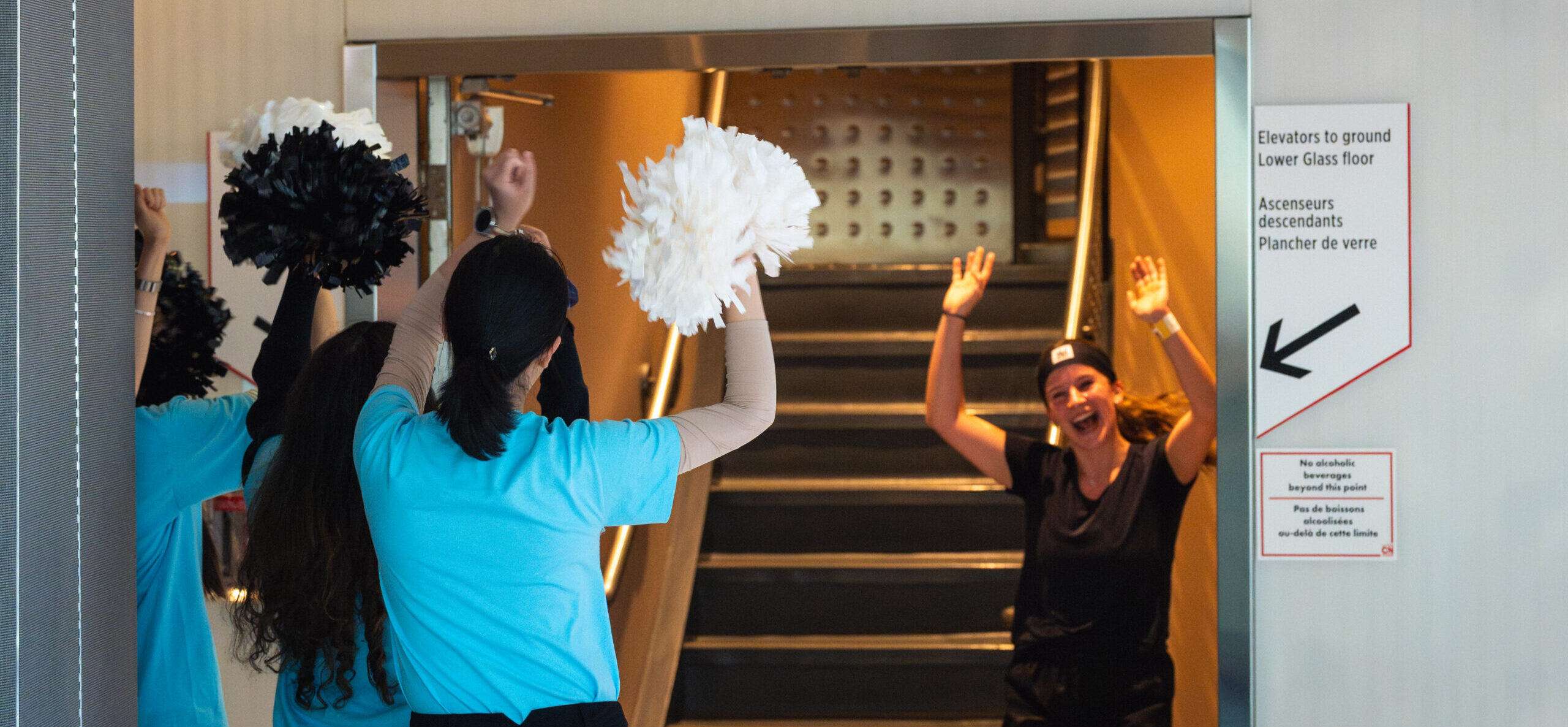 Cimber celebrating with people shaking pompoms