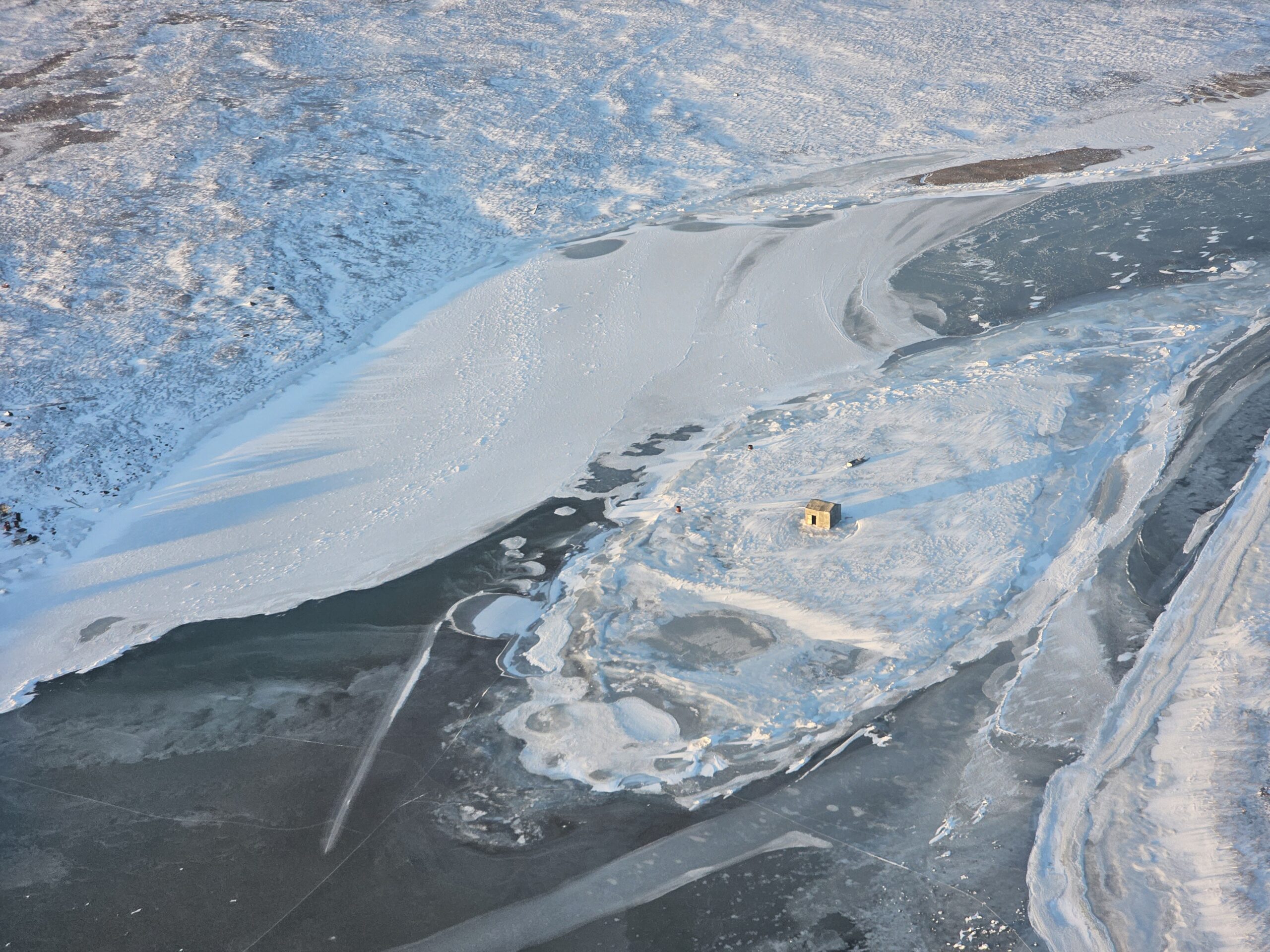 Small cabin on a frozen lake