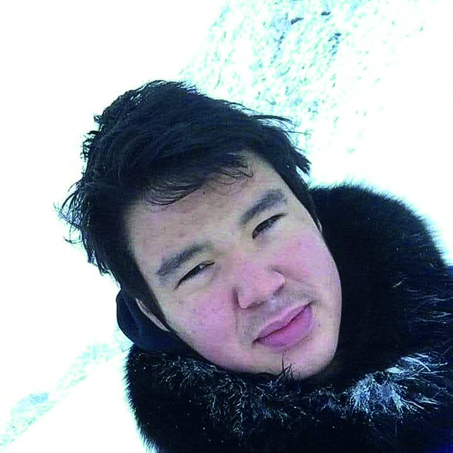 A man taking a selfie with ice in the background