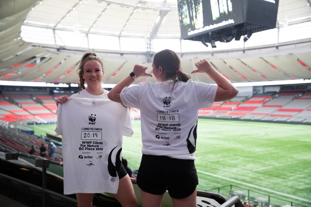 Lindsay Carey and friend show off their BC Place Climb for Nature T-shirts with their climb times. Lindsay finished in 20:19