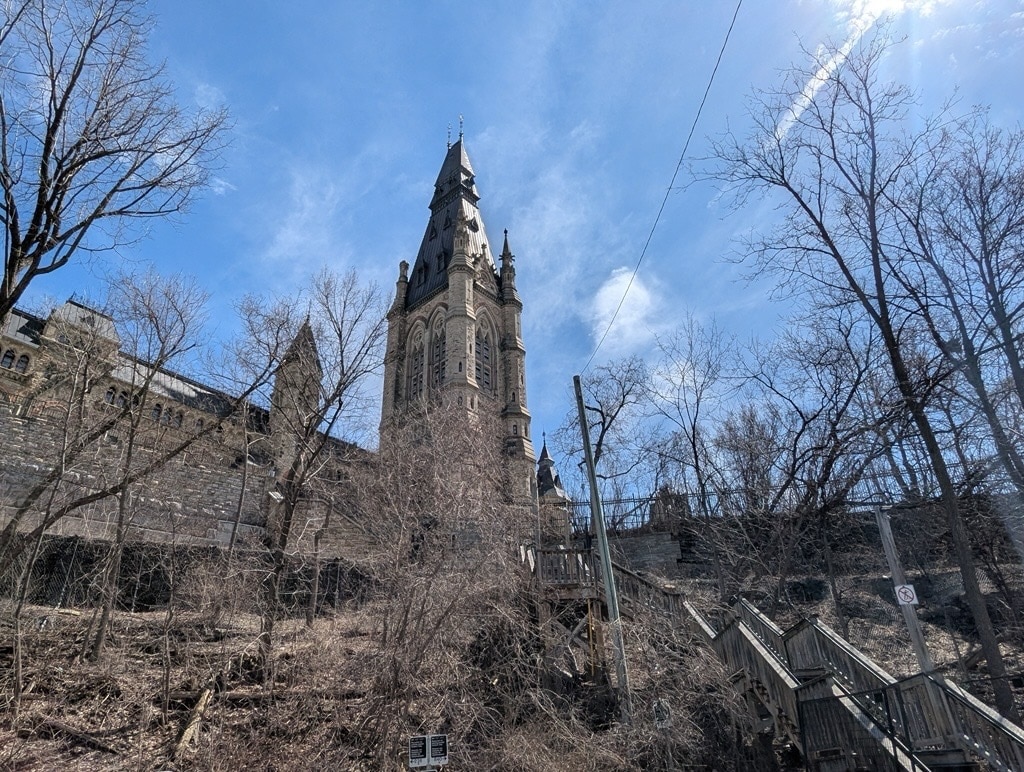 Old building surrounded by trees and blue sky