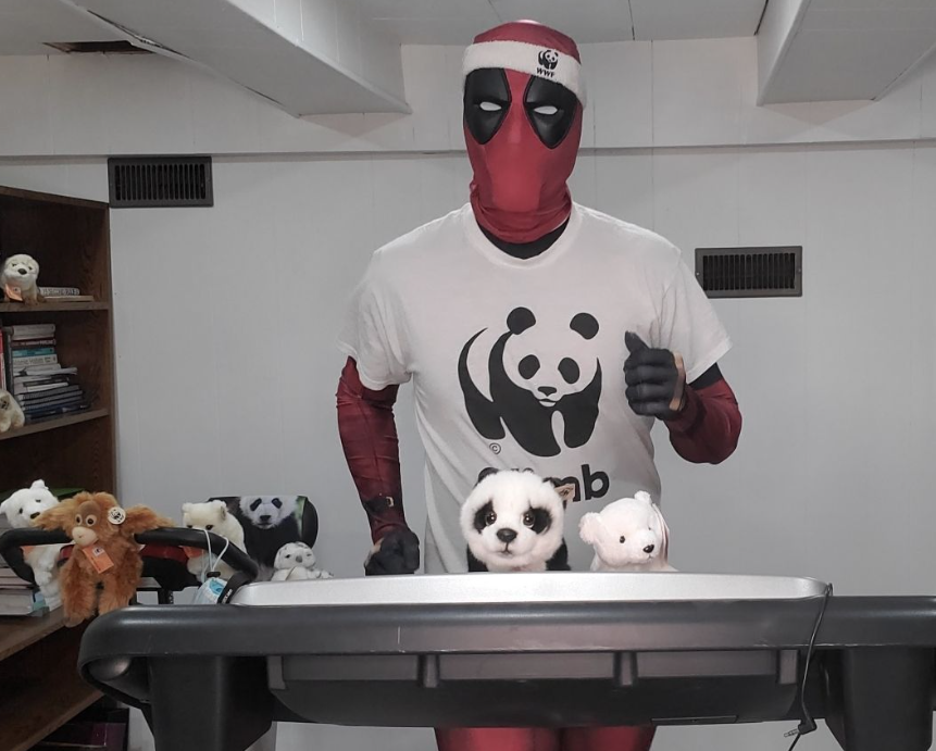 Reece David running on a treadmill in a Deadpool costume and WWF T-shirt. 