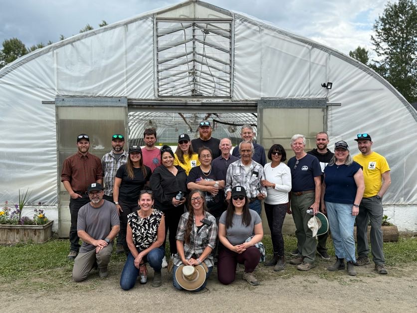 a group of people standing outside a nursery for plants