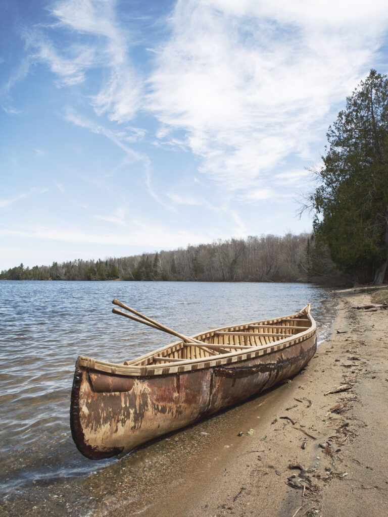 Birch canoe on sandy bank
