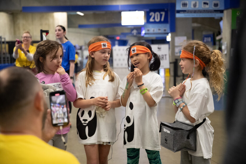 A group of four young girls being interviewed after finishing the BC Place Climb for Nature